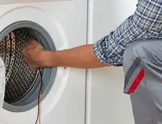Dryer repair technician diagnosing and servicing a clothes dryer in Jackson, MS